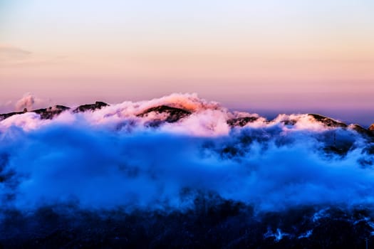 Landscape with pink clouds over mountain and sky horizon in Tenerife island, Spain at sunset