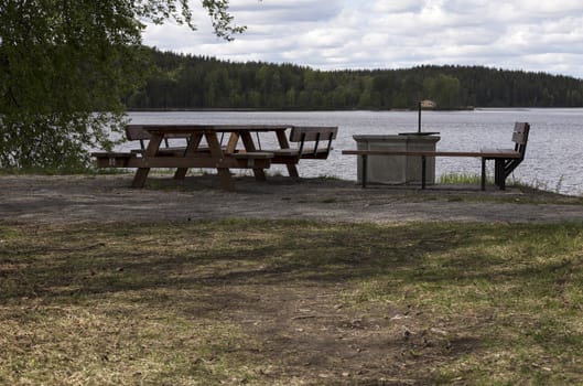 A rest area with some benches in front of the ocean