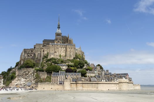 A distance photo on Mont St Michel in Normandy France with a blue sky and some clouds