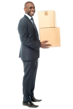 Full length of businessman carrying cardboard boxes.