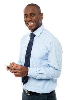 Happy businessman with his cell phone over white