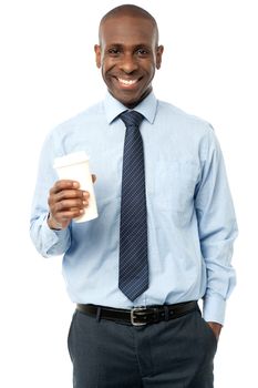 Smiling male executive with disposable cup over white