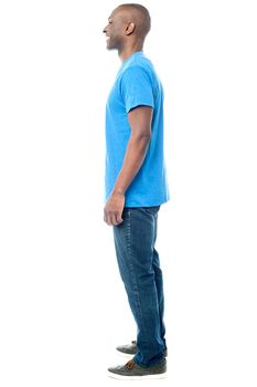 Full length of casual man posing sideways