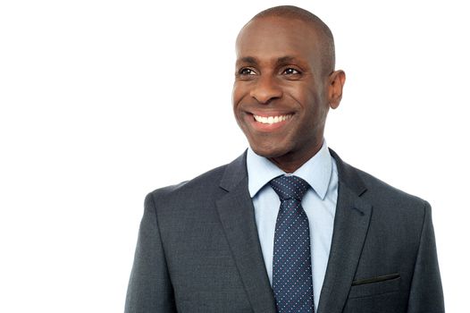 Confident businessman looking at something over white