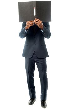 Businessman has covered his face with folder