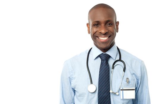Confident male physician smiling at camera over white