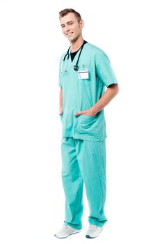 Full length of male doctor with hands in pockets