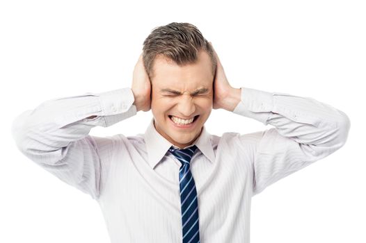 Frustrated man covering his ears with hands