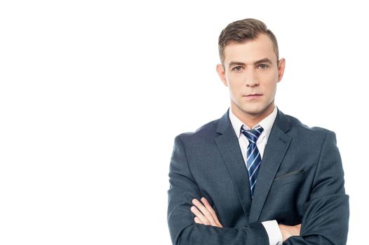 Young handsome businessman with folded arms.