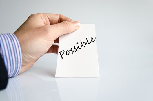 Business man hand writing Possible