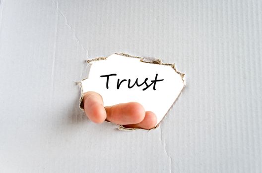 Hand and text on the cardboard background Trust