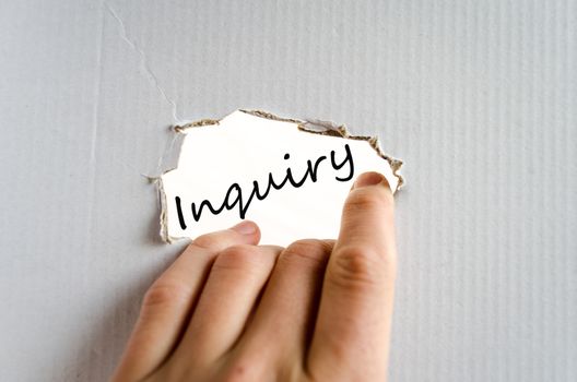 Hand and text on the cardboard background Inquiry