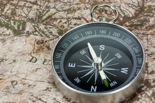 Close up of a compass on an old map