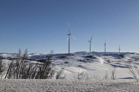 Some wind turbines on a mountain at the border between sweden and norway