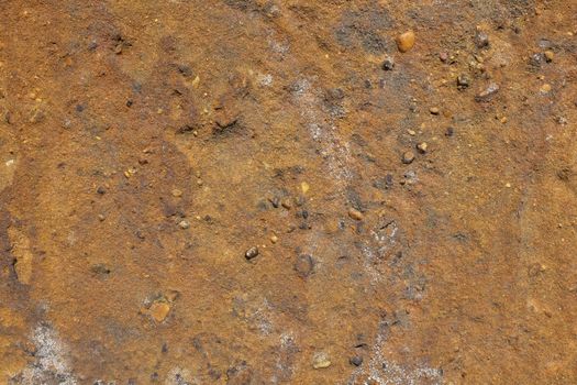 Gritty golden brown sandstone abstract background texture with small stones