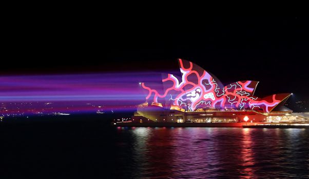 SYDNEY, AUSTRALIA - MAY 25, 2015;   Light beams stream onto the iconic landmark, the Sydney Opera House casting various moving patterns during Vivid Sydney annual festival event. Super high ISO to freeze the pattern