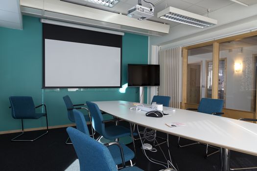 A conference room with a corridor outside