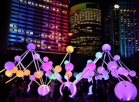 SYDNEY, AUSTRALIA, MAY 25, 2015:  Tourists and local public enjoy the Affinity installation at Vivid Sydney, which  depict the dazzling complexity and connectivity of the human brain and neurons.  When stimulated by touch, the orbs set-up a striking display of sound and light.  People in motion.  Artists:  amigo & amigo (Simone Chua & Renzo B. Larriviere ) + S1T2 (Chris Panzetta & Naimul Khaled)