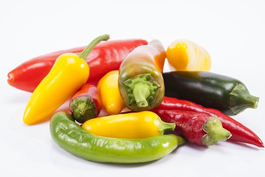heap of colorful raw chili pepper isolated on white background