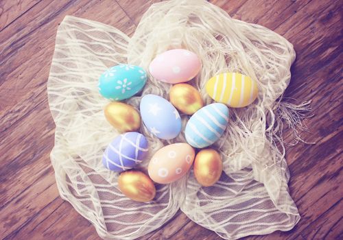 Top view of colorful easter eggs on cloth with retro filter effect