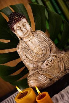Buddha statue with orchid flower