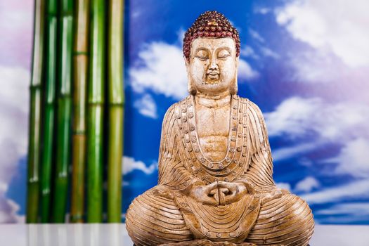 Buddha statue with orchid flower