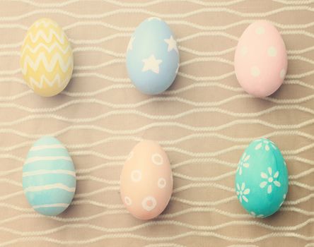 Top view of colorful easter eggs on cloth with retro filter effect