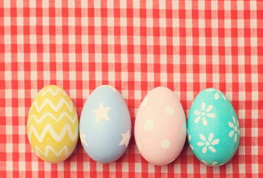 Colorful easter eggs on tablecloth with retro filter effect