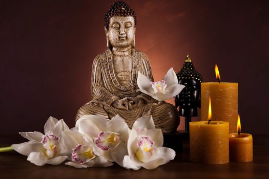 Buddha statue with orchid flower