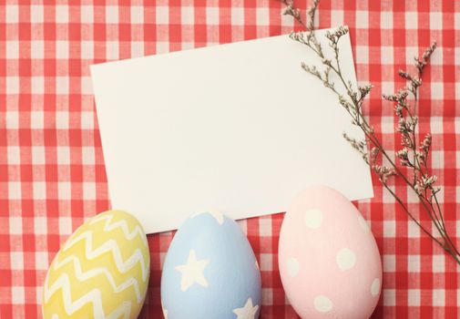 Colorful easter eggs and blank note paper with retro filter effect