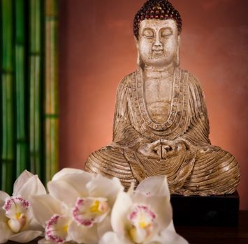 Buddha statue with orchid flower