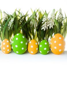 Easter Eggs with flower on Fresh Green Grass over white background