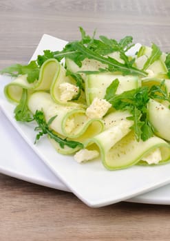 Salad from zucchini ribbon with arugula and feta