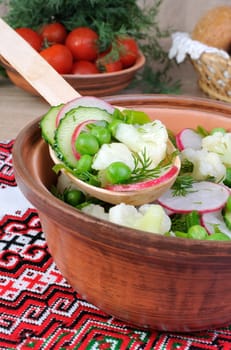 Cauliflower salad with cucumber, radish, peas and onions