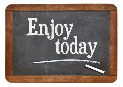 Enjoy today - positive words on a vintage slate blackboard