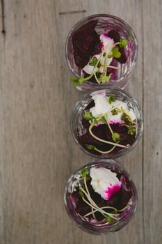 Vegetarian aperitif with beet, goat cheese and soy sprouts