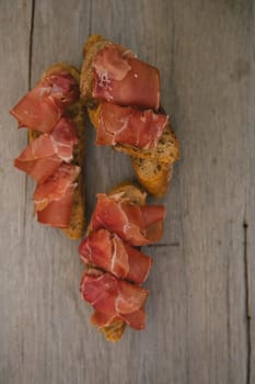 sliced prosciutto on a wooden board. Close up