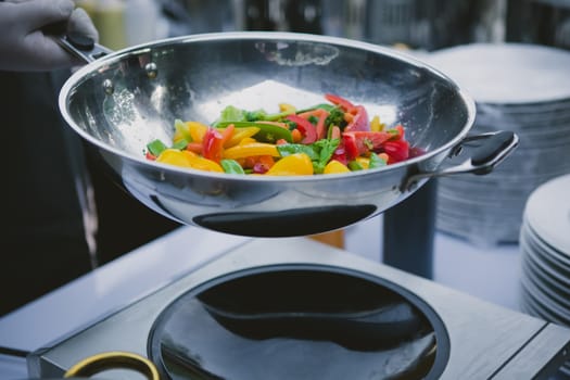 Chef cooking vegetables in wok pan. Shallow dof