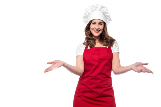 Beautiful female chef welcoming with warm smile