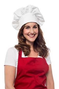 Middle aged female chef posing over white 