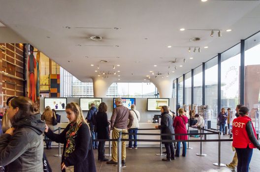 Amsterdam, Netherlands - May 6, 2015: Tourist visit Stedelijk Museum in Amsterdam located in the museum park, Netherlands on May 6, 2015.