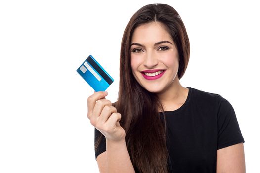 Smiling woman showing her credit card to camera
