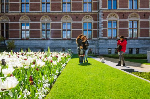Amsterdam, Netherlands - May 6, 2015: Tourists at the garden around the Rijksmuseum, The Rijksmuseum is a Netherlands national museum dedicated to arts and history in Amsterdam.