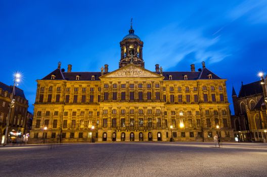 Amsterdam, Netherlands - May 7, 2015: People visit Royal Palace at Dam Square in Amsterdam, Netherlands. Its notable buildings and frequent events make it one of the most well-known and important locations in the city and the country.