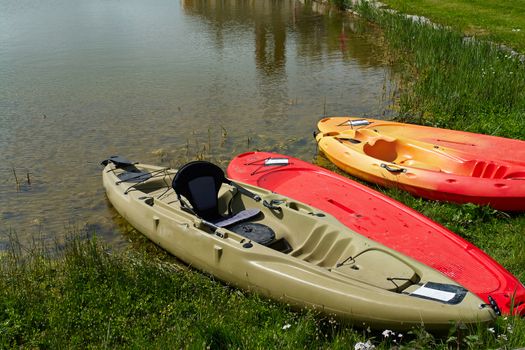 Colorful kayaks on the beach ready for extreme sport activity                                        
