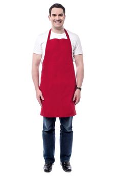 Full length of happy male chef posing over white