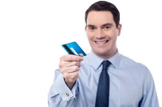 Smiling male executive offering his credit card