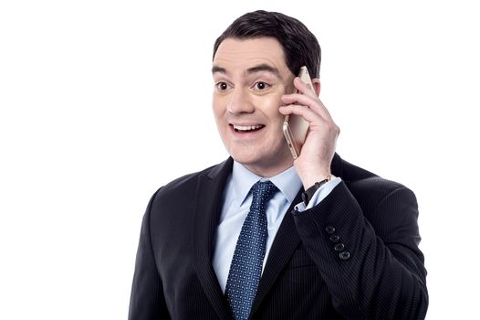 Excited businessman talking on his cell phone