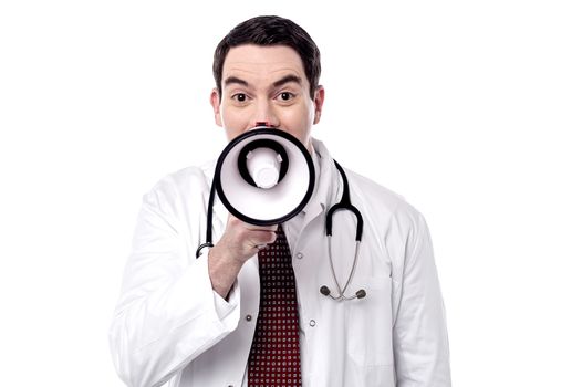 Happy physician proclaiming into megaphone over white