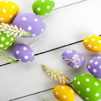 Easter background with colorful eggs over white wood